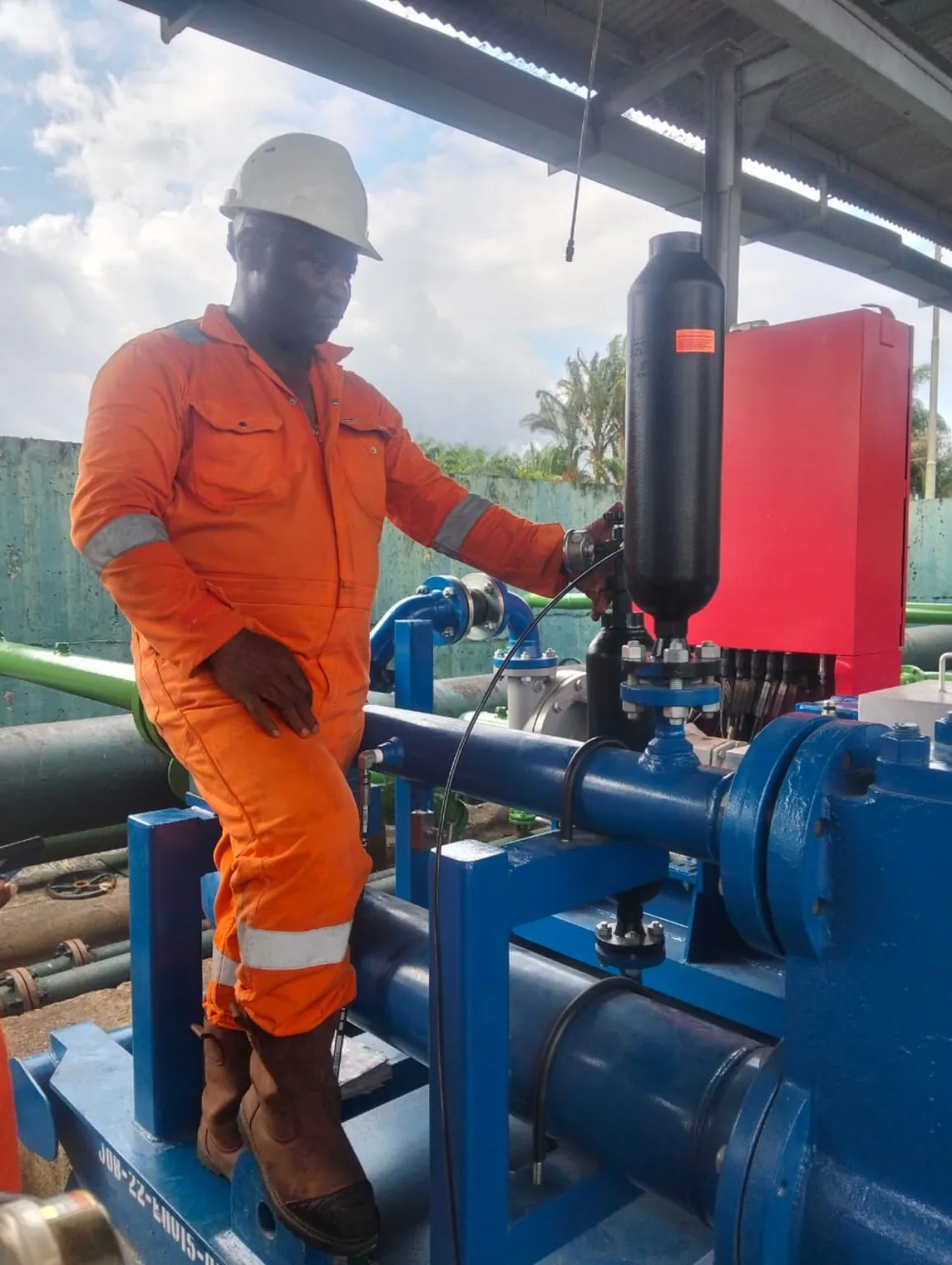 Technician operating an industrial export pump and its control equipment